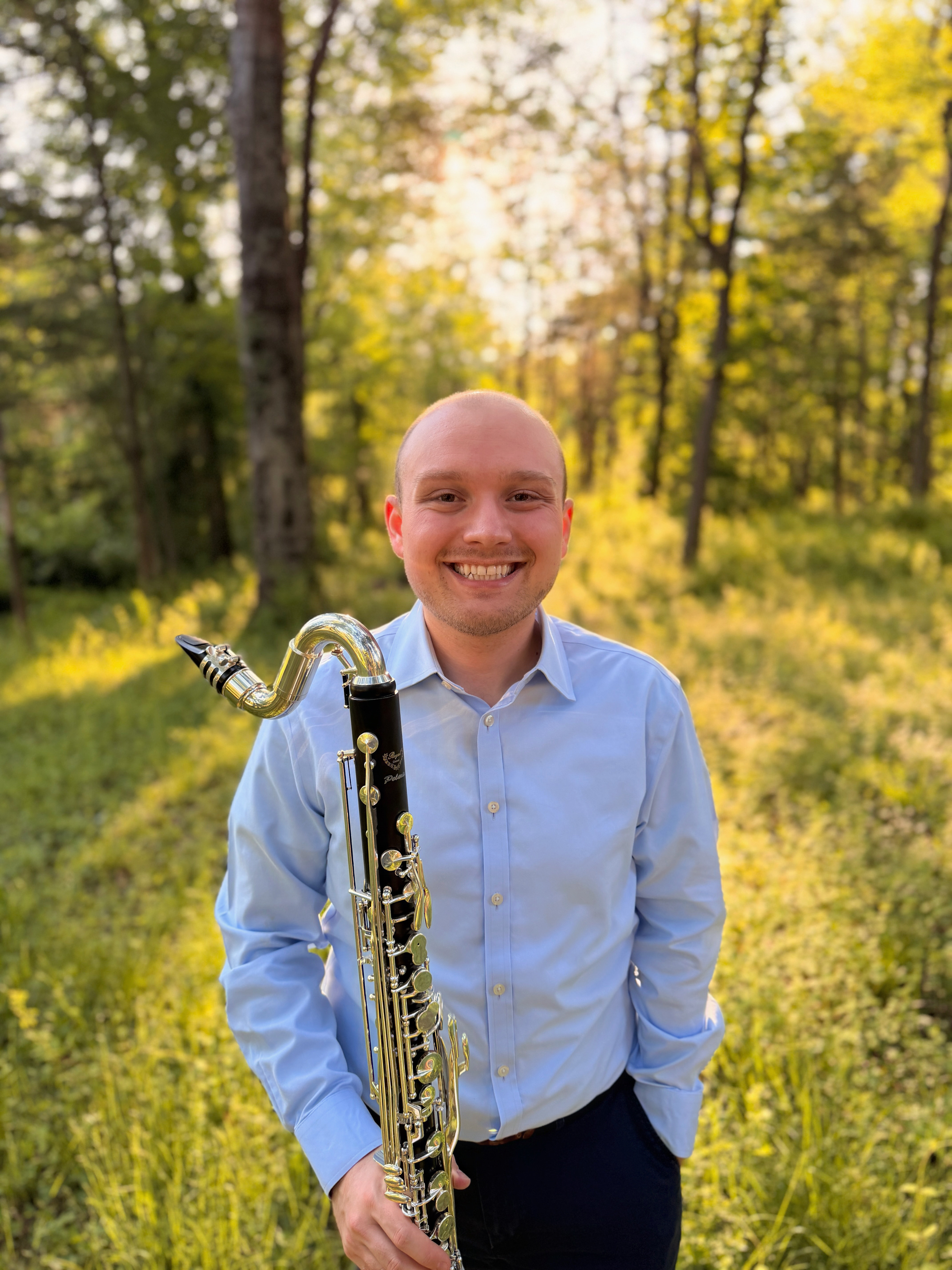 Matthew Weger holding a bass clarinet